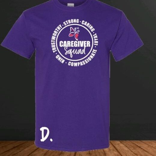 A purple t-shirt with the words caregiver squad on it.